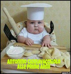 a baby sitting in a high chair wearing a chef's hat and eating chips