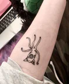 a small tattoo on the arm of a woman's arm, with an image of a deer