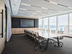 an empty conference room with large windows overlooking the city