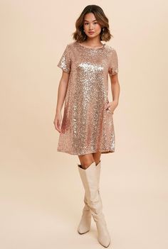 Your next night out calls for the Swifty Sequin Shirt Dress In Rose Gold! Shimmering sequins deck out this stunning shift dress with a round neckline, short sleeves, and a flirty mini-hem length. Get ready for the complements! Fully lined for comfort Round necklineShort sleevesSparkle sequin dressLow V back Invisible s Taylor Swift Sequin Dress, Taylor Swift Sequin, Champagne Sequin Dress, Sequin T Shirt Dress, Sequin Shirt Dress, Sequin Tshirt, Eras Outfit, Rose Gold Sequin Dress, Dress Sparkle