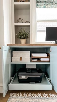 a desk with a computer and printer on it