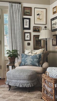 a living room filled with furniture and framed pictures on the wall above it's windows