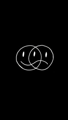 two circles with faces drawn on them in the middle of a black background, and one circle