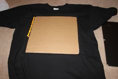 a cardboard box sitting on top of a black shirt