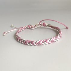 the pink and white braid bracelet is on display