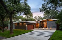 a modern house is lit up at night