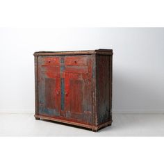 an old wooden cabinet with two doors on one side and a drawer on the other