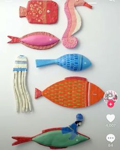 an assortment of colorful fish and sea creatures on a white surface with text overlay