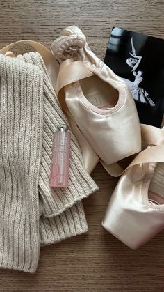 ballet shoes, socks and a book on the floor