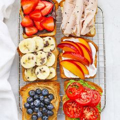 an assortment of fruits and sandwiches on a cooling rack