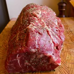 a large piece of meat sitting on top of a wooden table