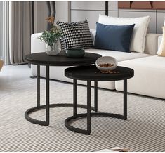 two tables sitting next to each other on top of a carpeted living room floor