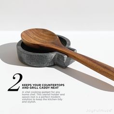 a wooden spoon sitting on top of a stone container