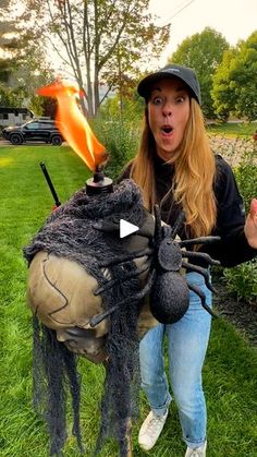 a woman sitting on top of a fake horse with a flame in it's mouth