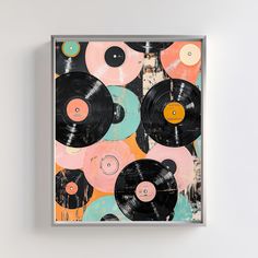 an art piece with vinyl records on it in front of a white wall and grey frame