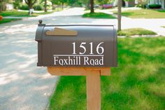 a mailbox with the words foxhill road written on it in front of a sidewalk