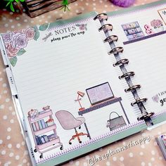 an open planner book sitting on top of a table