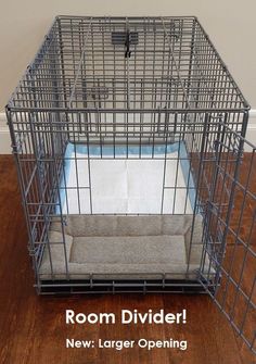 a dog cage with the words room divider next to it on a wooden floor