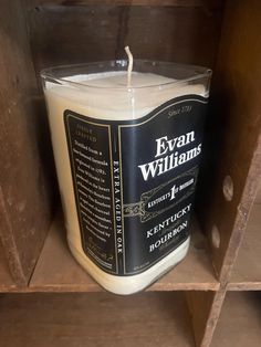 a candle is sitting on top of a wooden shelf