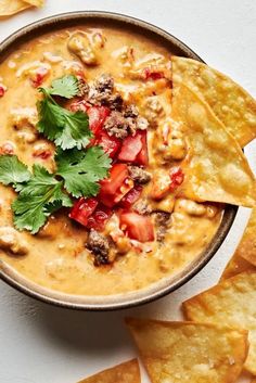 a bowl filled with tortilla chips and salsa