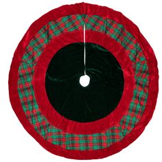 a red and green plaid christmas tree skirt hanging on a white wall with a black hole in the center