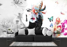 a living room with a couch and wall mural