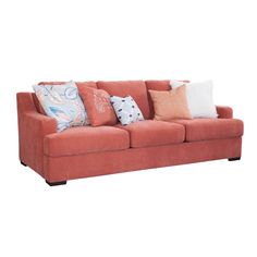 an orange couch with many pillows on it's back and sides, against a white background