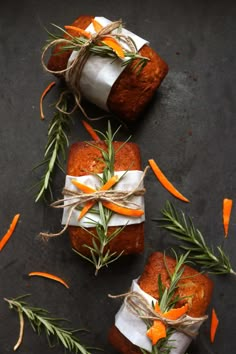 carrot bread wrapped in paper and tied with twine on top of a black surface