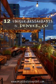 an outdoor dining area with wooden tables and chairs at night, lit up by string lights