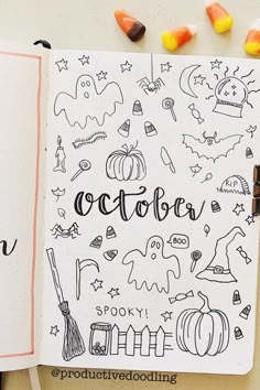 an open notebook with halloween doodles and candy