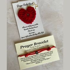 a card with a red heart on it and a prayer bracelet attached to the back