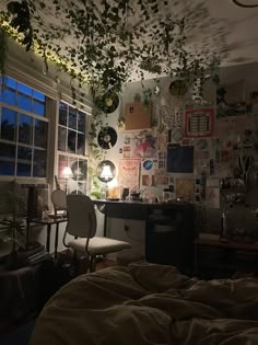 a bedroom with lots of plants hanging from the ceiling