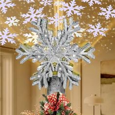 a christmas tree decorated with snowflakes and bows