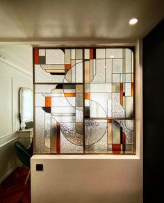 a large stained glass window in the corner of a room