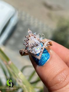 a woman's hand holding a diamond ring with blue glitter on the outside and inside