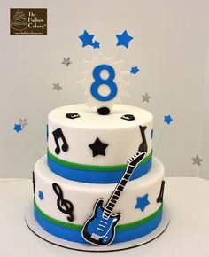 a birthday cake with a guitar and stars on it