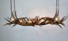 an antler chandelier hanging on a wall