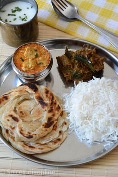 a silver plate topped with different types of food