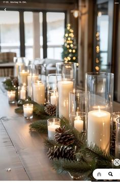 a long table with candles and pine cones on it