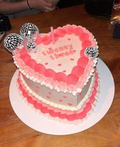 a heart shaped birthday cake on a table