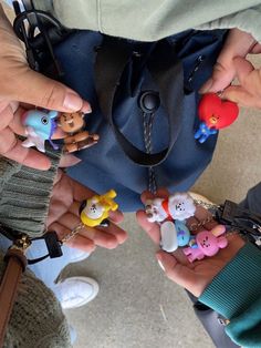 several people holding small toy animals in their hands