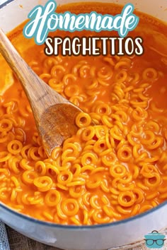 a wooden spoon in a large pot filled with homemade spaghetti soup and the title overlay reads homemade spaghetti