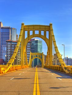 the yellow bridge is going across the street