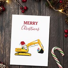 a christmas card with an image of a bulldozer and candy canes on the table