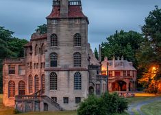 an old building with many windows and a clock on the top of it's tower