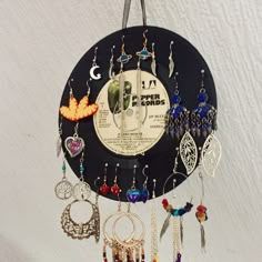 a clock with many different earrings hanging from it