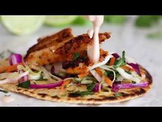 chicken and coleslaw on a tortilla with dressing drizzled over it