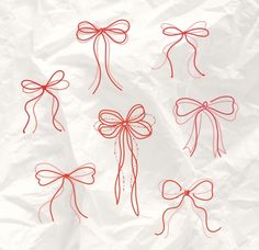 six red bows on crumpled paper with one tied up and the other knoted down