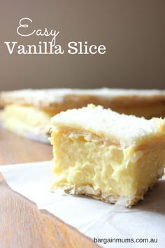 a piece of cake sitting on top of a wooden table next to a white napkin