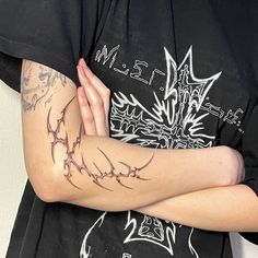 a person with tattoos on their arms